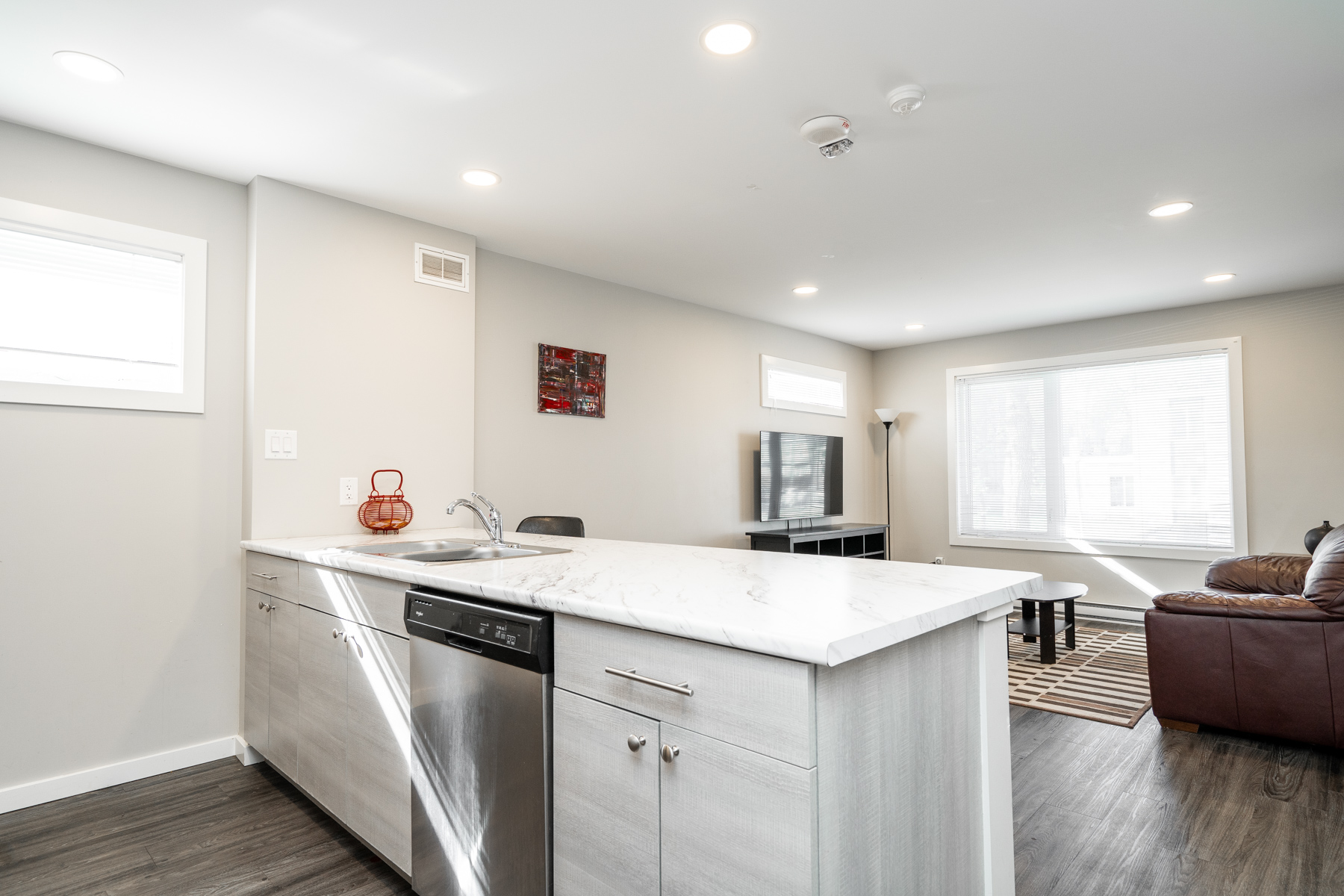 bright photo of kitchen island and living room